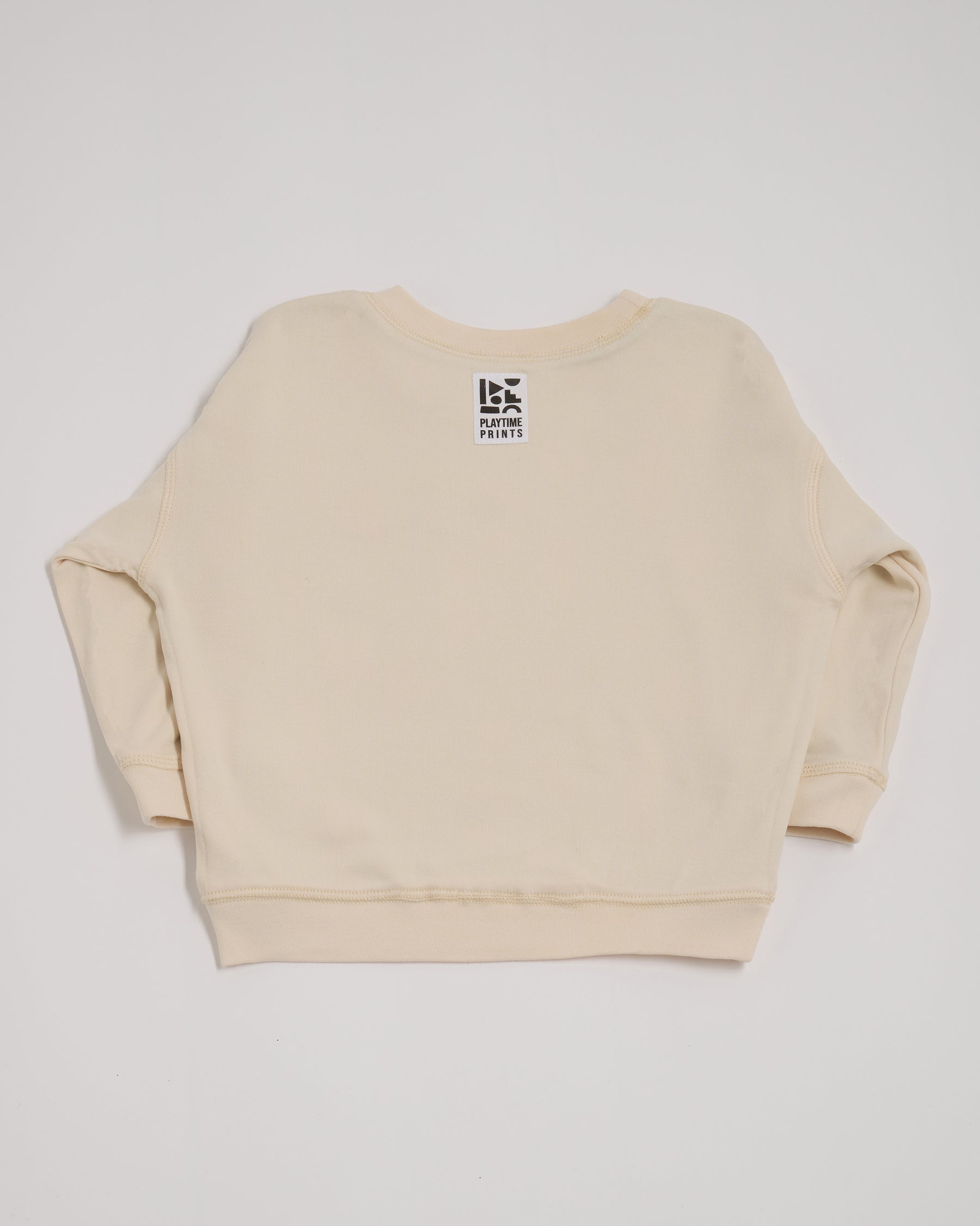 Back of ecru sweatshirt showing Playtime Prints brand label.
