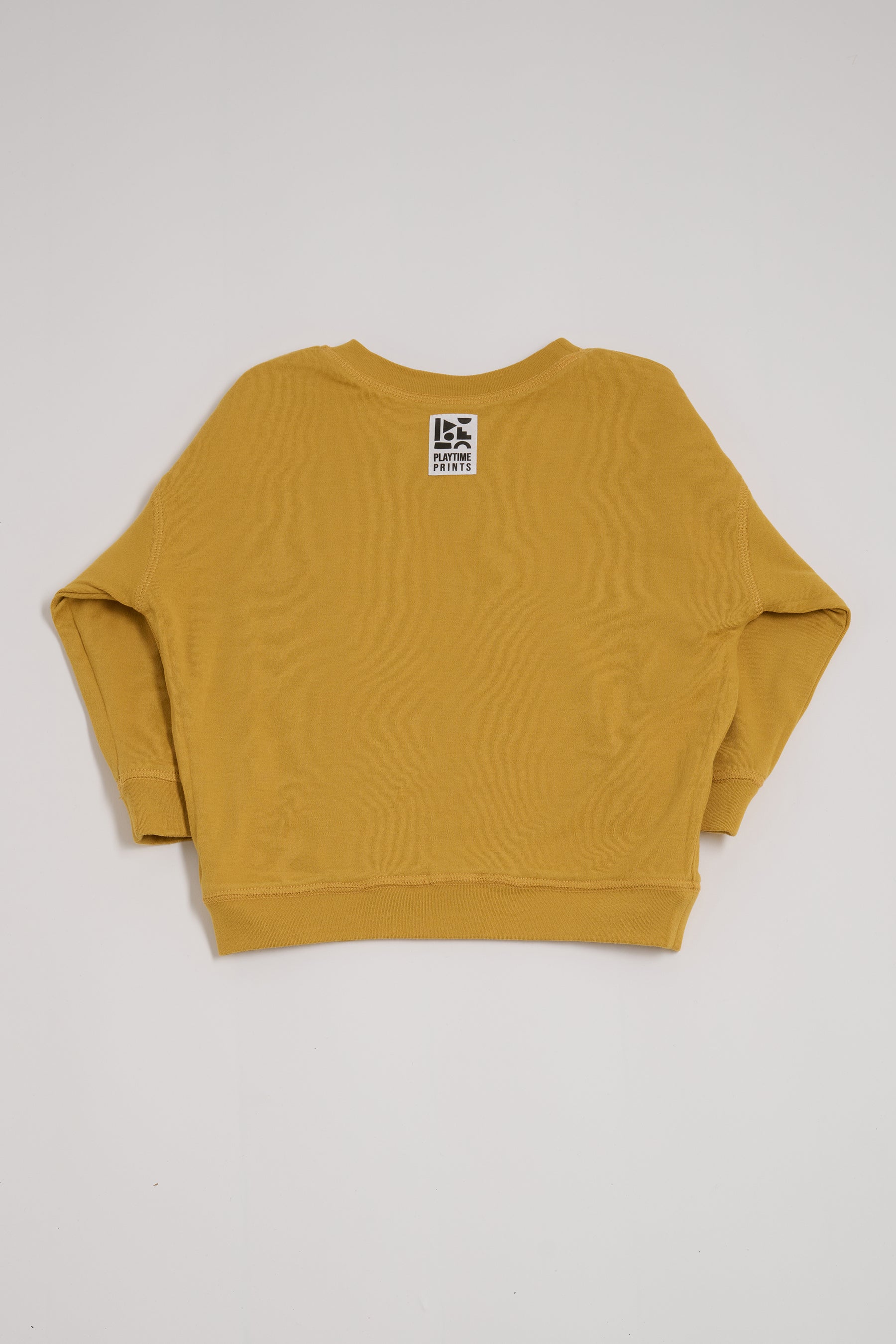 Back of honey coloured sweatshirt showing Playtime Prints brand label.