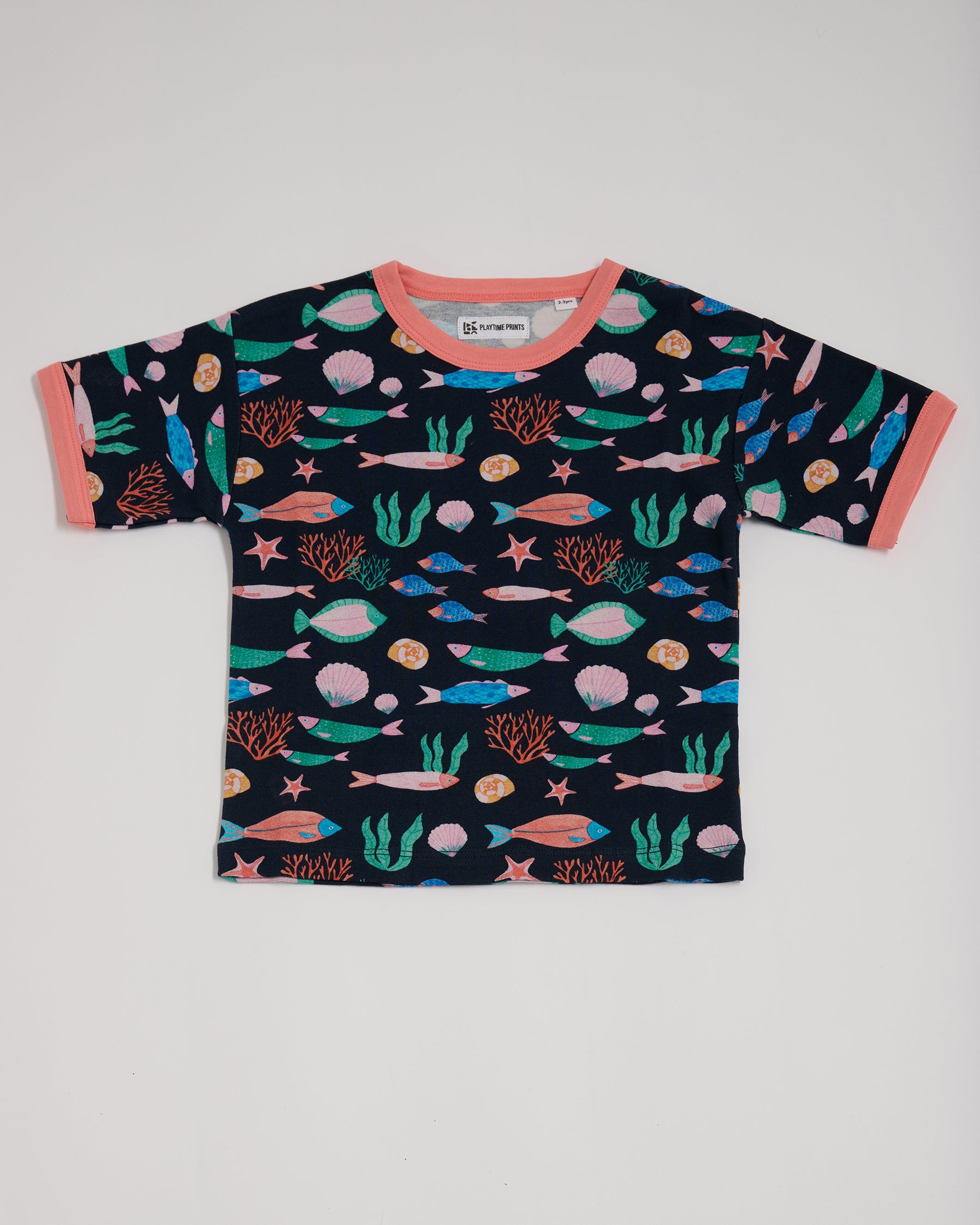 Front of short sleeved t-shirt featuring an all over vibrant navy fish print with contrast coral neck and sleeve trim.