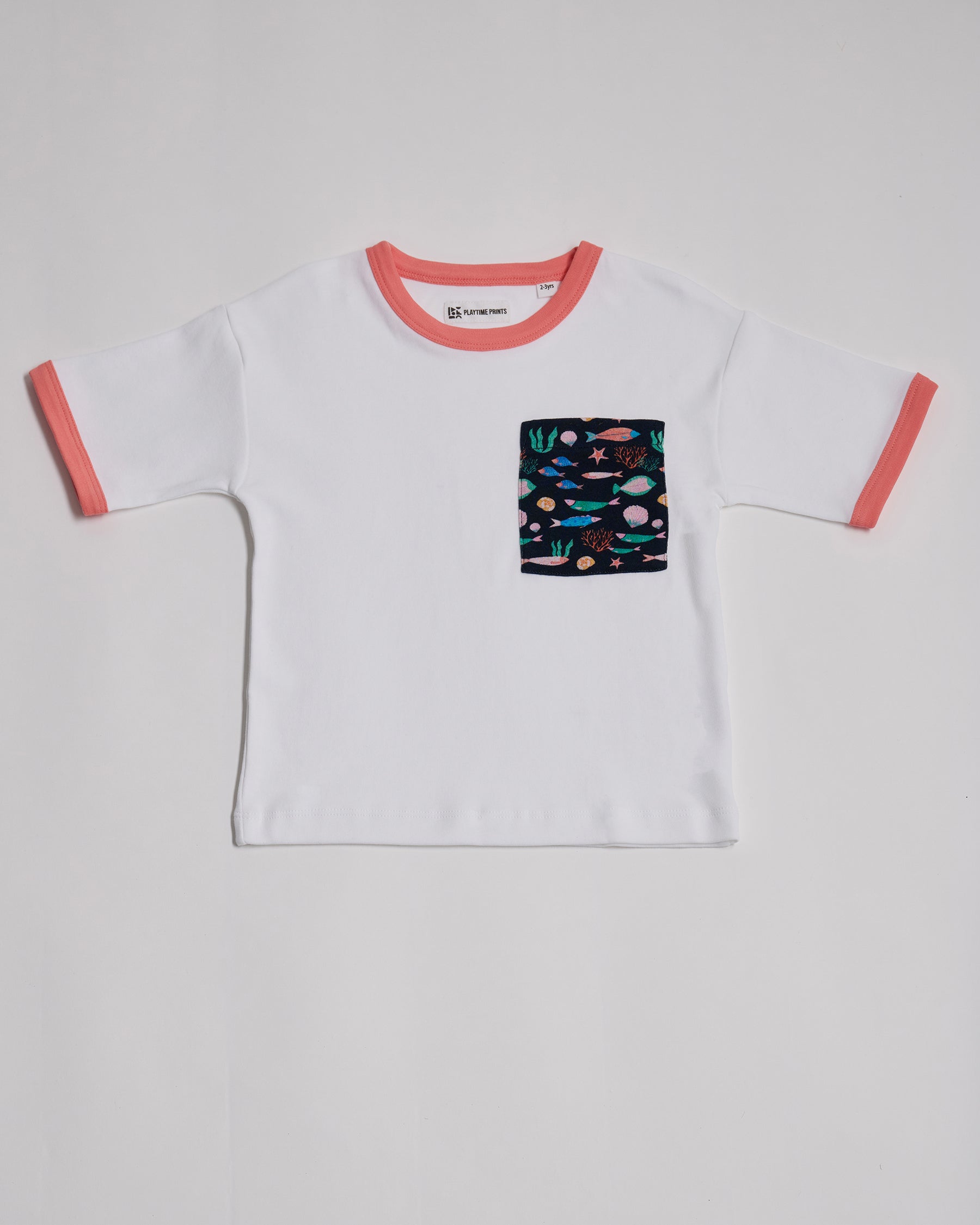 Front of white short sleeved t-shirt with vibrant fish print square chest pocket and coral neck and sleeve trim.
