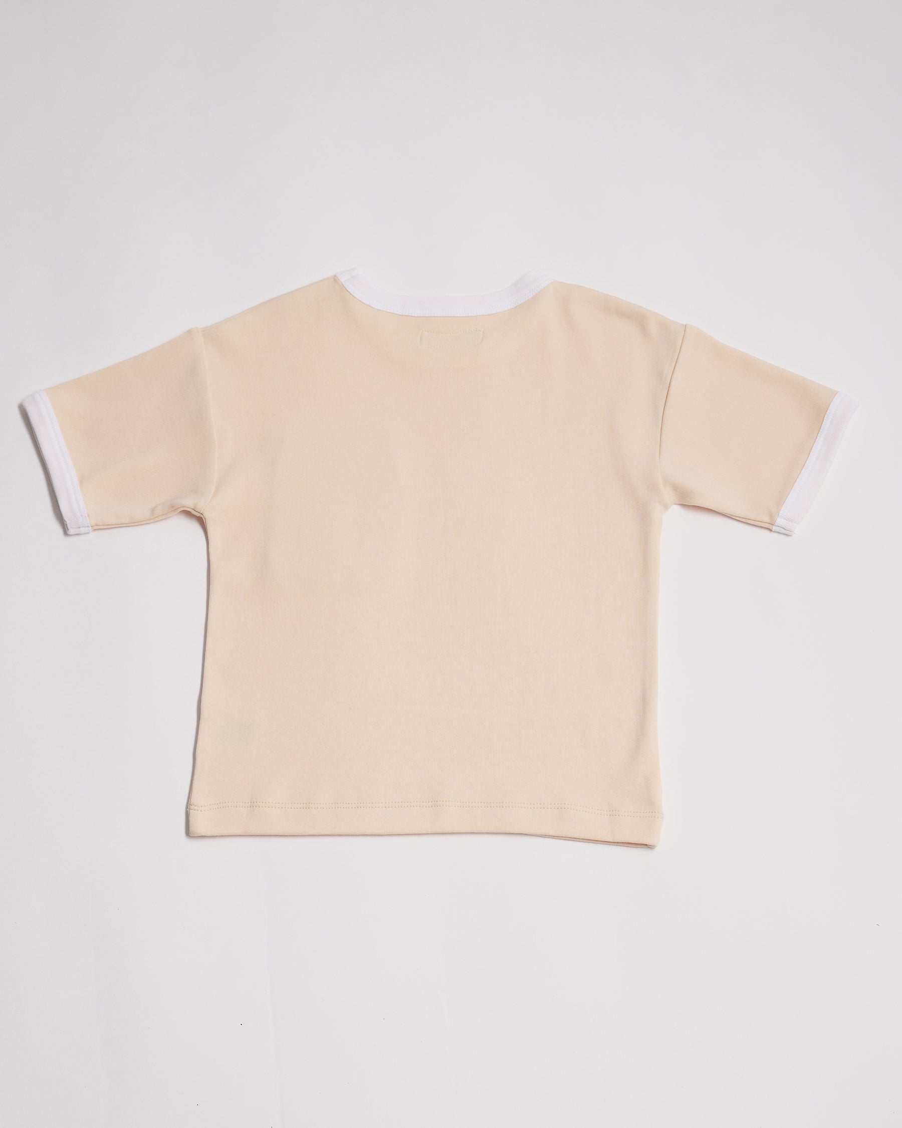 Back of vanilla coloured short sleeved t-shirt with white neck and sleeve trim.