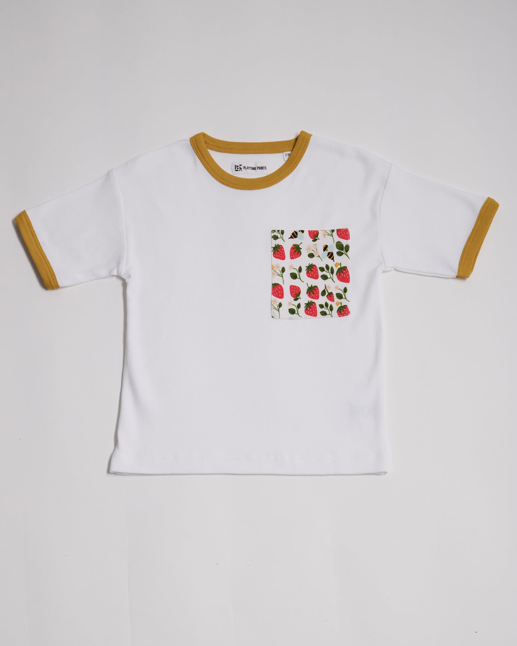 Front of white short sleeved t-shirt with fun strawberry and bees print square chest pocket and honey neck and sleeve trim.