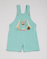 Front of turquoise short dungarees with bright ice cream print pocket, vanilla buttons and vanilla trim.