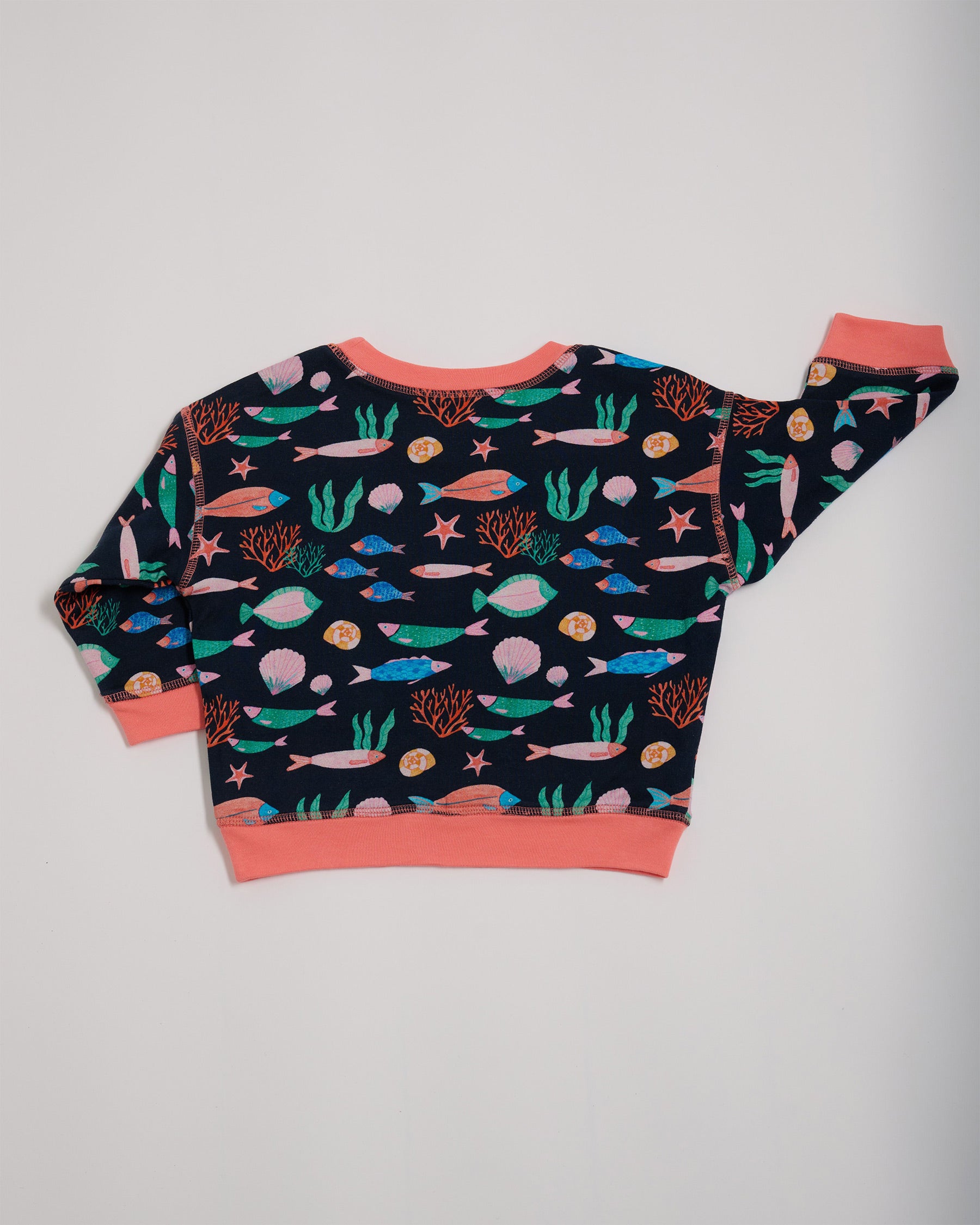 Back of featuring an all over vibrant navy fish print with contrast coral neck and sleeve trim.